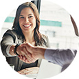 A business woman shaking hands with coworker