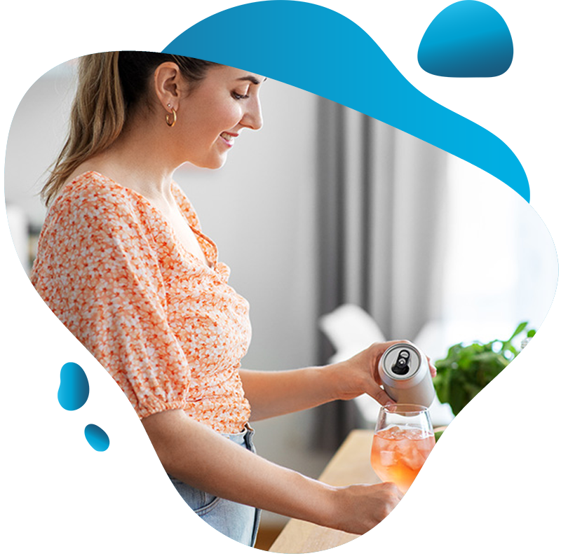 Smiling woman pouring a drink from an aluminum can into a glass of ice.