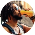 Hip young man drinking from can